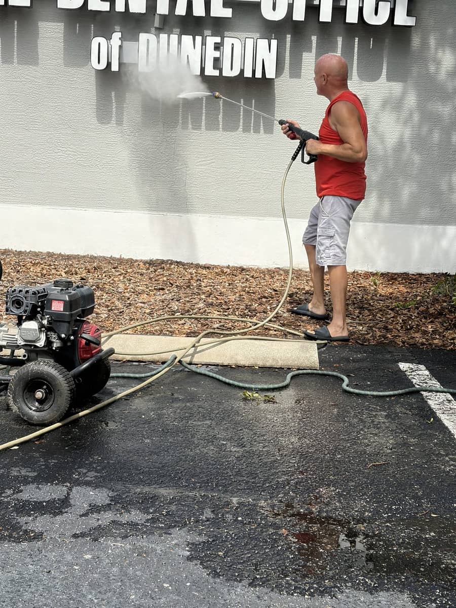 Commercial pressure washing of a business sign and exterior wall in Dunedin FL, Tom's Professional Power Wash Plus